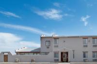 Un edificio blanco con un cielo azul al fondo. en Super 8 by Wyndham Taos, en Taos