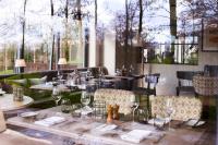 a dining room with tables and chairs and windows at The Fish Hotel in Broadway