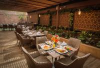 um restaurante com mesas e cadeiras com comida em Hotel Lomas 10 Medellin em Medellín