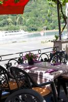a table with flowers on it on a balcony at Hotel Zwei Mohren in Rüdesheim am Rhein