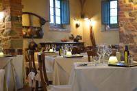 a restaurant with tables with white tablecloths and wine glasses at Cortona Resort-Le Terre Dei Cavalieri in Cortona