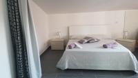 A bed or beds in a room at Lilium In B&B