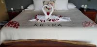 a bed with a swan made out of red pedals at Casa Arcoiris Zihuatanejo B&B in Zihuatanejo