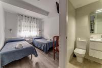 Postel nebo postele na pokoji v ubytování Hostal Lar