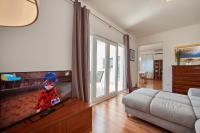 Televízia a/alebo spoločenská miestnosť v ubytovaní Apartmani Sara i Klara