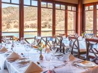 a dining room with a table with wine glasses at Kloofzicht Lodge & Spa in Muldersdrift