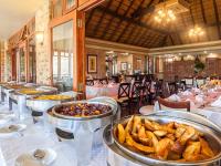 a restaurant with several trays of food on a table at Kloofzicht Lodge & Spa in Muldersdrift