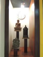 a clock and statues on display in a room at Dickman Resort "The Boutique Hotel" in Negombo