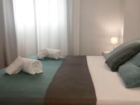 A bed or beds in a room at Apartamentos Albertos