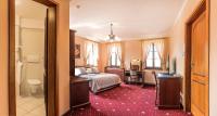 Postel nebo postele na pokoji v ubytování Hotel Buchlovice