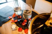 two champagne glasses on a table next to a sink at La Suite Romantique avec Jacuzzi au Cœur de Perpignan in Perpignan