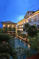 a hotel with a swimming pool in front of a building at Gallery Prawirotaman Hotel in Yogyakarta