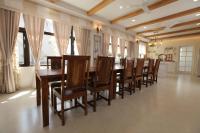 a dining room with a long table and chairs at Happiness Pass On in Wujie