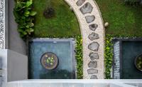 an aerial view of a garden with a table in the water at Eastin Ashta Resort Canggu in Canggu