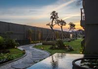 a garden with a stone walkway in a yard at Eastin Ashta Resort Canggu in Canggu