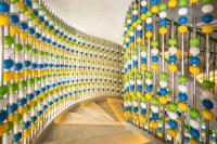 a hallway with colorful balls on the wall at Eastin Ashta Resort Canggu in Canggu