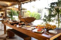 a table with a bunch of food on it at Pousada Casa do Catavento in Búzios
