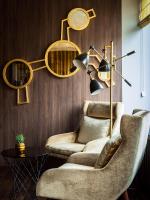 a living room with a chair and a lamp at AMERON Hamburg Hotel Speicherstadt in Hamburg