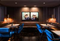 a dining room with tables and blue chairs at AMERON Hamburg Hotel Speicherstadt in Hamburg