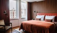 a hotel room with a bed and a window at AMERON Hamburg Hotel Speicherstadt in Hamburg
