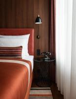 a bedroom with a bed and a side table at AMERON Hamburg Hotel Speicherstadt in Hamburg