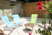 two lawn chairs and a table in a patio at Birchbank Cottage in Coulommiers