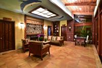 a living room with chairs and a fireplace at TFG B&amp;B in Lugu Lake