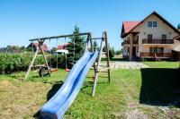 a blue slide in a yard with a house at Casa Din Gradina Lui Ioan in Tărlungeni