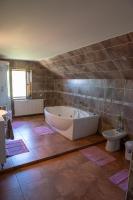 a large bathroom with a tub and a toilet at Casa Din Gradina Lui Ioan in Tărlungeni