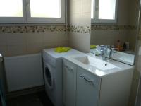 a bathroom with a sink and a washing machine at Studio Centre Ville Office De Tourisme in Bayonne