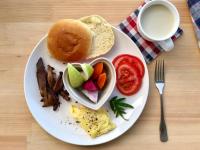 a plate of breakfast food with a bagel and a cup of coffee at Liang Chen Mei Jin B&amp;B in Shuangxi