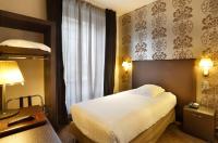 a hotel room with a bed and a window at Hôtel de Paris in Besançon