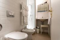 a white bathroom with a toilet and a sink at MULTIRESIDENCE L&#39;ELYSEE Paris in Paris