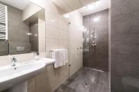 a white bathroom with a sink and a shower at Hotel Nowy Dwór in Trzebnica