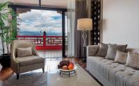 a living room with a couch and a table with fruit on it at The Grand Hotel in Taipei