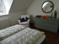 a bedroom with a bed and a mirror and a chair at Mosel Dream in Cochem