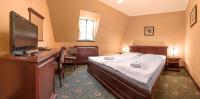 Postel nebo postele na pokoji v ubytování Hotel Buchlovice