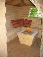 a sauna with a bench in a wooden house at Les Ecolodges de l&#39;Orbière in Forcé