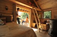 a man and a woman standing in a room with a ladder at Les Ecolodges de l&#39;Orbière in Forcé