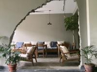 a living room with a table and chairs at Hotel Blossom in Pokhara