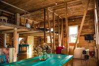 a living room with wooden walls and a blue table at Casa Apel Hostel in Puerto Varas