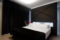 a bedroom with a large bed with a black headboard at Axel Hotel Barcelona - Adults Only in Barcelona