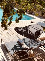 a chair sitting on a deck next to a swimming pool at Maison TANDEM in Cluny