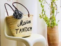 a burlap bag on a white chair with plants at Maison TANDEM in Cluny