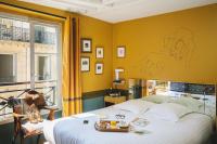 a bedroom with a bed with a drawing on the wall at Hôtel Crayon in Paris