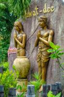 a statue of two women standing next to a vase at Haadson Resort & Koh Raham in Haad Son
