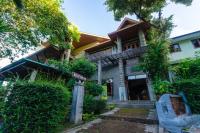 a house with a street sign in front of it at Haadson Resort & Koh Raham in Haad Son