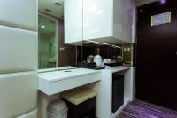 a bathroom with a white sink and a mirror at Harmonious Hotel in Kaohsiung