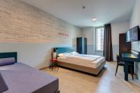 A bed or beds in a room at MEININGER Milano Lambrate