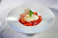 a white plate with a dish of food on a table at Hotel Restaurant L&#39;Ami Fritz in Ottrott